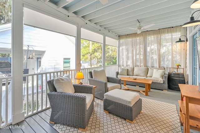 sunroom featuring beam ceiling and ceiling fan