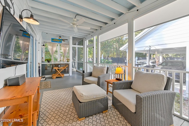 sunroom with vaulted ceiling with beams and ceiling fan