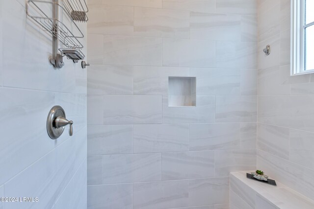 bathroom with tiled shower