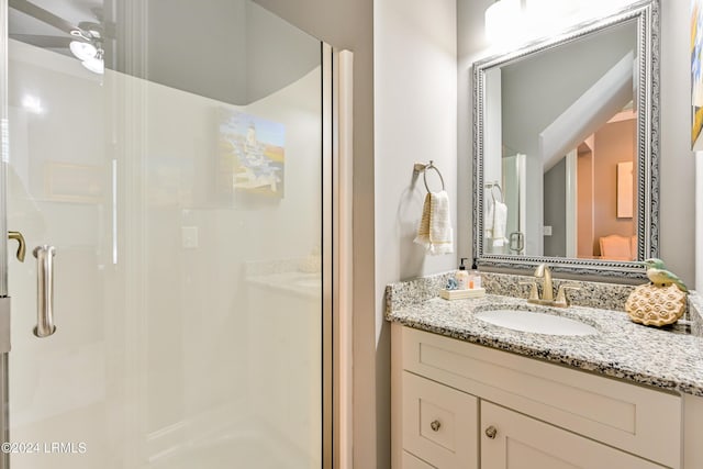 bathroom featuring vanity, an enclosed shower, and ceiling fan