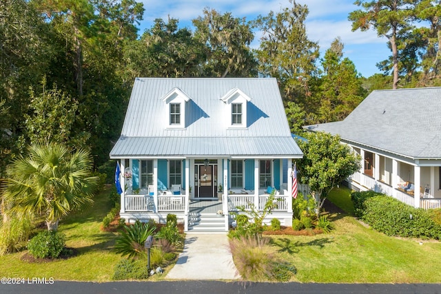 view of front of home with covered porch and a front yard