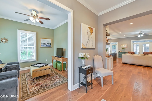 living room featuring ornamental molding, ceiling fan, light hardwood / wood-style floors, and french doors