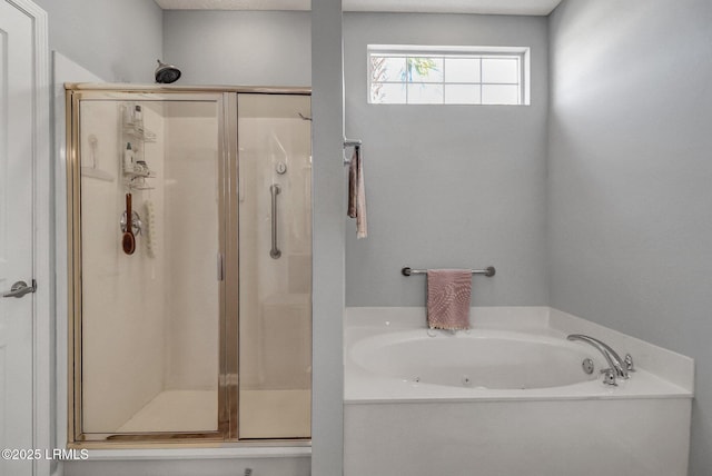 bathroom with a stall shower and a bath