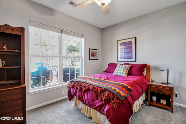 bedroom featuring visible vents, multiple windows, carpet, and baseboards