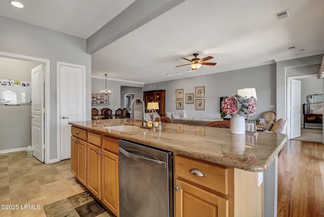 kitchen featuring open floor plan, stainless steel dishwasher, visible vents, and a sink