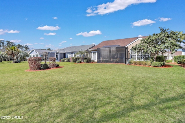 view of yard with glass enclosure