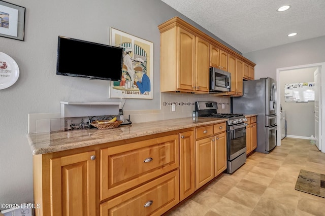 kitchen with light stone counters, recessed lighting, stainless steel appliances, decorative backsplash, and a textured ceiling