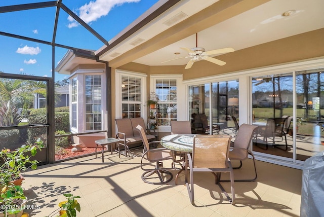 sunroom featuring ceiling fan