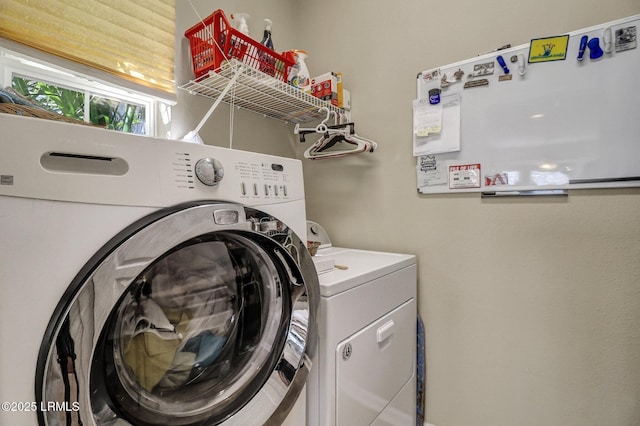 laundry area featuring washing machine and clothes dryer and laundry area