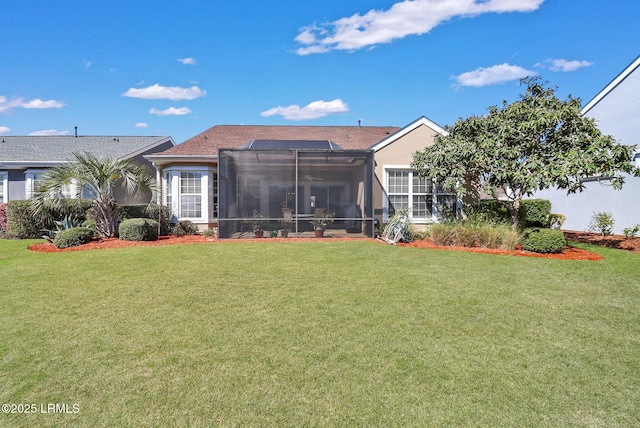 back of property with a lanai and a yard