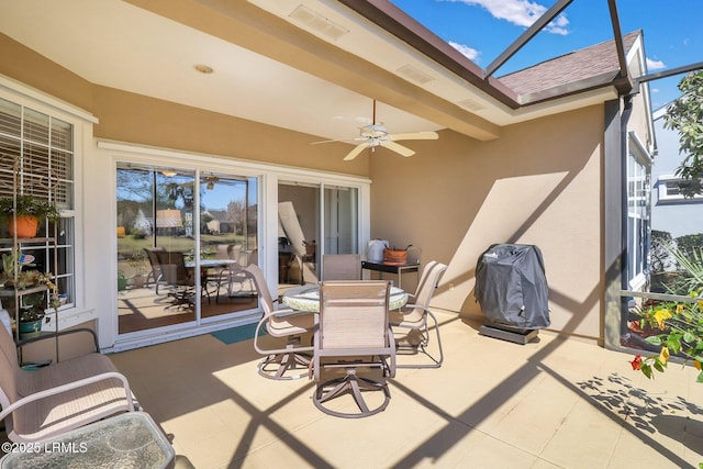 view of patio / terrace featuring a lanai, grilling area, outdoor dining space, and a ceiling fan