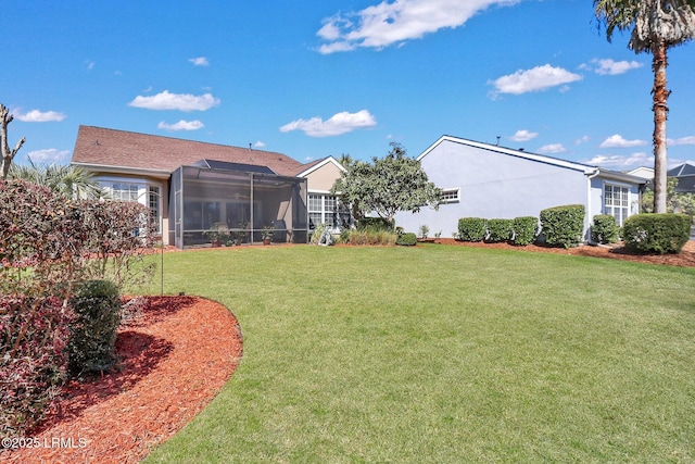 view of yard with glass enclosure