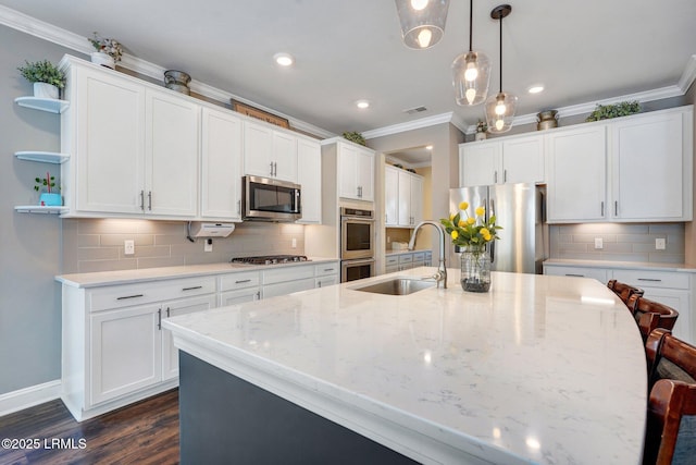 122 Bedstone Ct, Bluffton, SC 29909 - kitchen with ornamental molding, open shelves, a center island with sink, appliances with stainless steel finishes, and a sink