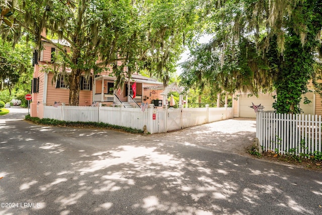 view of front of home featuring a garage, a gate, driveway, and a fenced front yard