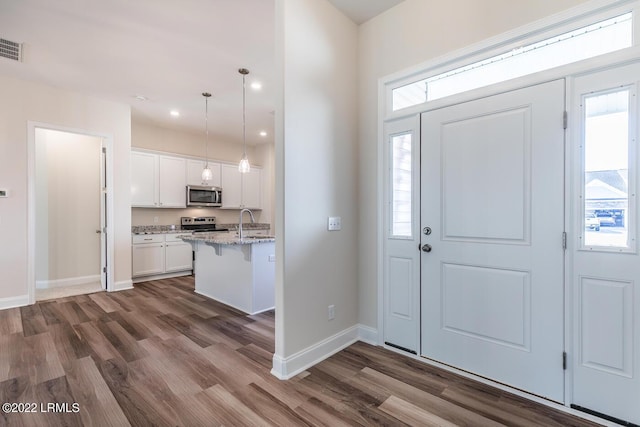 foyer featuring dark hardwood / wood-style flooring and sink