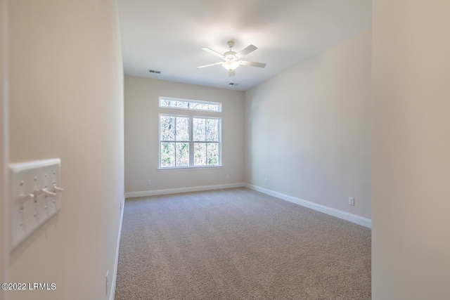 carpeted empty room featuring ceiling fan