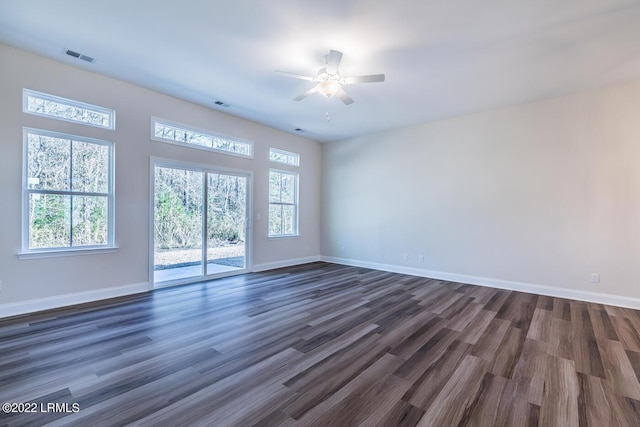 spare room featuring dark wood-type flooring and ceiling fan