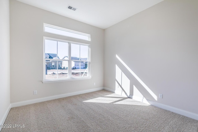 empty room featuring light carpet