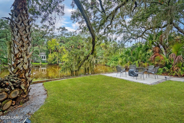 view of yard featuring a patio area and a water view