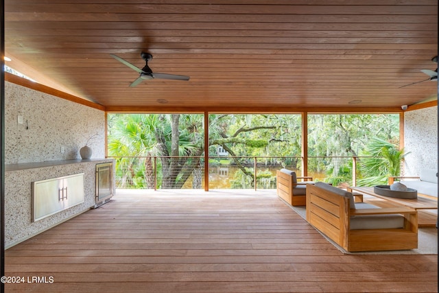 wooden deck featuring ceiling fan and outdoor lounge area