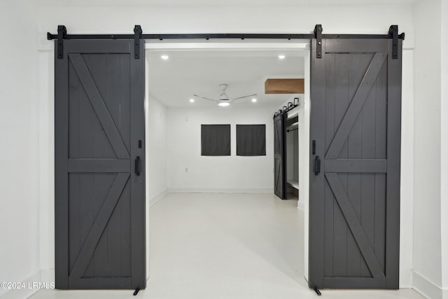 interior space featuring concrete flooring and a barn door