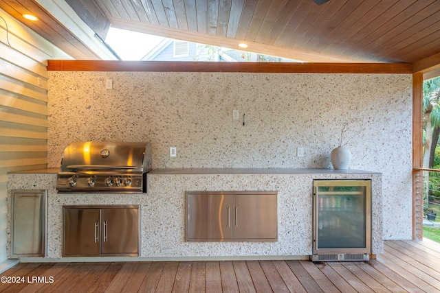 wooden deck featuring a grill and exterior kitchen