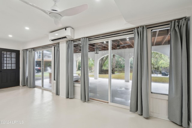 doorway featuring ceiling fan and a wall unit AC