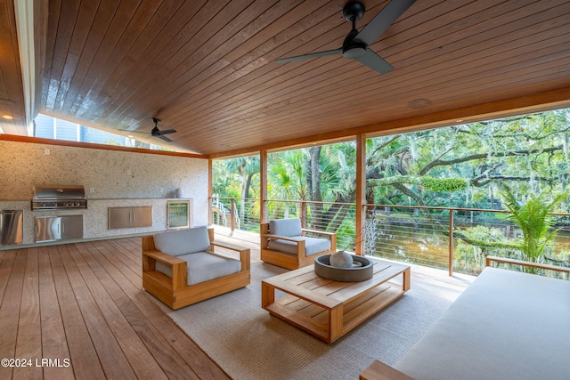 sunroom / solarium with lofted ceiling, wooden ceiling, and ceiling fan