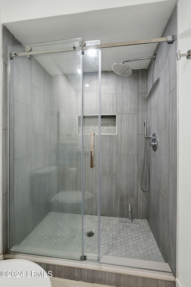 bathroom with an enclosed shower and toilet