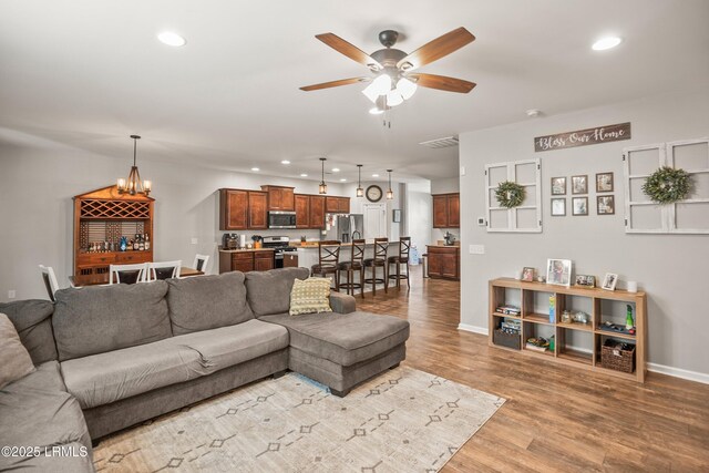42 Kiawah Dr, Beaufort, SC 29906 - living area featuring recessed lighting, a ceiling fan, wood finished floors, baseboards, and a chandelier