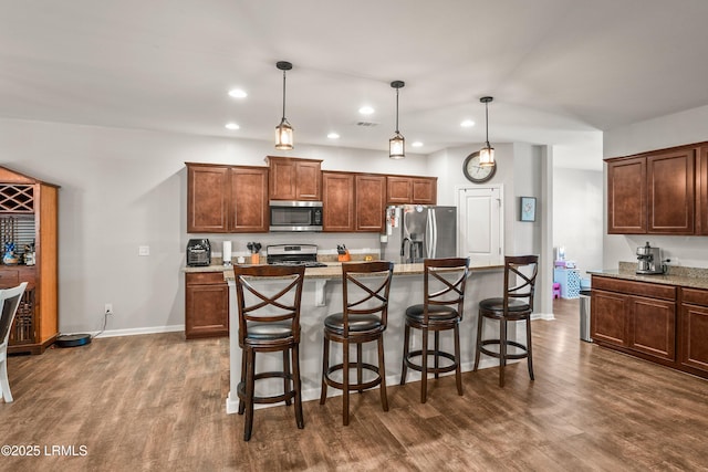 42 Kiawah Dr, Beaufort, SC 29906 - kitchen with appliances with stainless steel finishes, recessed lighting, dark wood finished floors, a breakfast bar, and hanging light fixtures