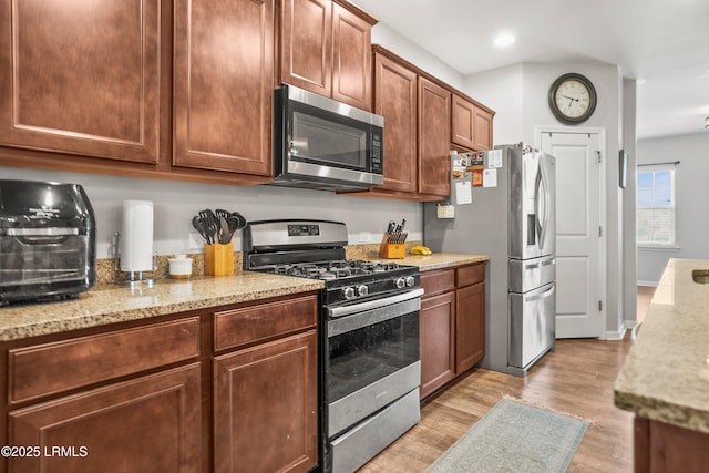 42 Kiawah Dr, Beaufort, SC 29906 - kitchen featuring stainless steel appliances, light wood-style flooring, light stone countertops, and recessed lighting