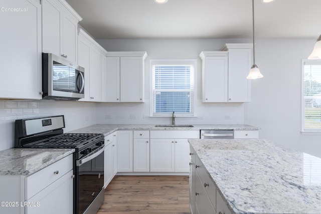 1111 Salty Hammock Ct, Beaufort, SC 29902 - kitchen featuring stainless steel appliances, light wood-type flooring, white cabinets, backsplash, and recessed lighting