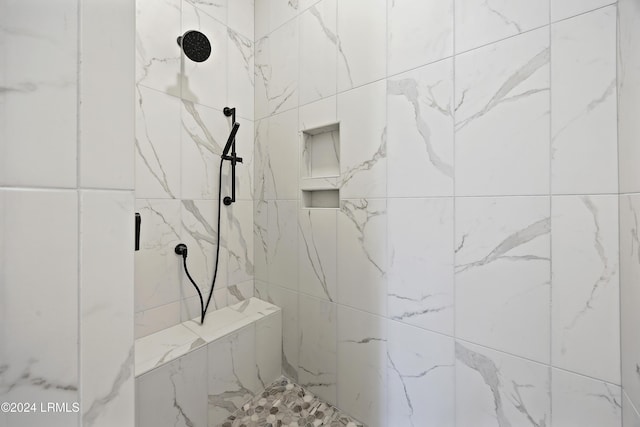 full bath with a tile shower