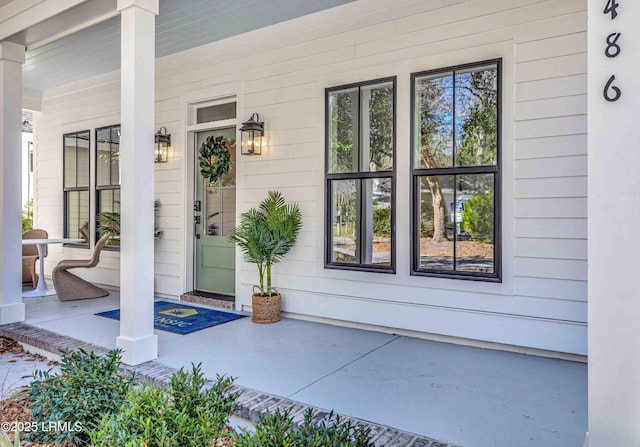 doorway to property featuring covered porch