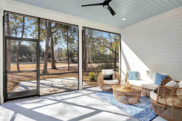 sunroom / solarium featuring ceiling fan