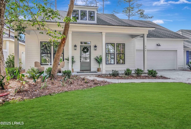 view of front facade with a front lawn, concrete driveway, a shingled roof, and an attached garage