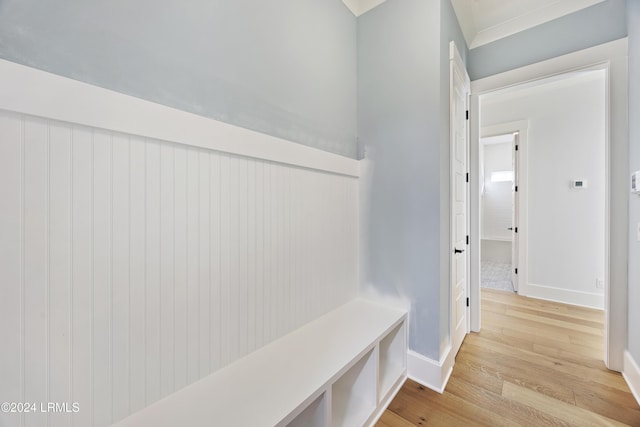 mudroom featuring light wood-style floors and baseboards