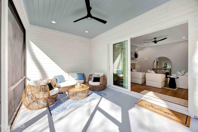 sunroom / solarium featuring ceiling fan and wood ceiling