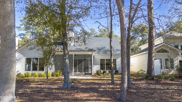 back of house featuring a sunroom