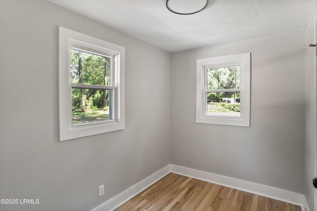 67 Sams Point Rd, Beaufort, SC 29907 - spare room with baseboards, a healthy amount of sunlight, and light wood-type flooring