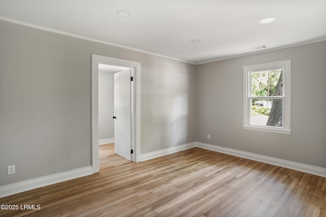 67 Sams Point Rd, Beaufort, SC 29907 - spare room featuring baseboards, crown molding, wood finished floors, and visible vents