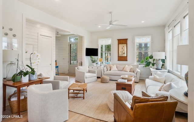 living room with ceiling fan and light wood-type flooring