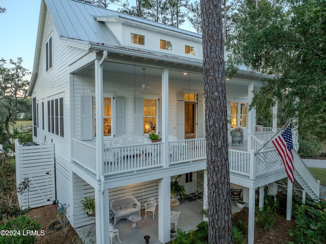 rear view of house featuring a patio and covered porch