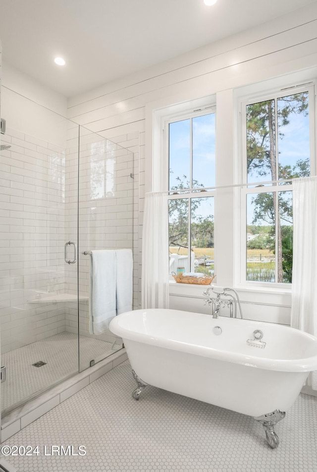 bathroom featuring tile patterned floors and shower with separate bathtub