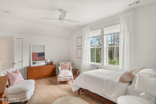 bedroom with vaulted ceiling, ceiling fan, and light hardwood / wood-style flooring