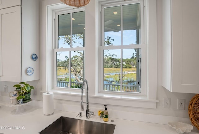 room details featuring white cabinetry and sink