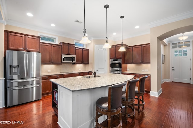 33 Little Pine Ct, Bluffton, SC 29910 - kitchen with stainless steel appliances, arched walkways, a center island with sink, tasteful backsplash, and visible vents