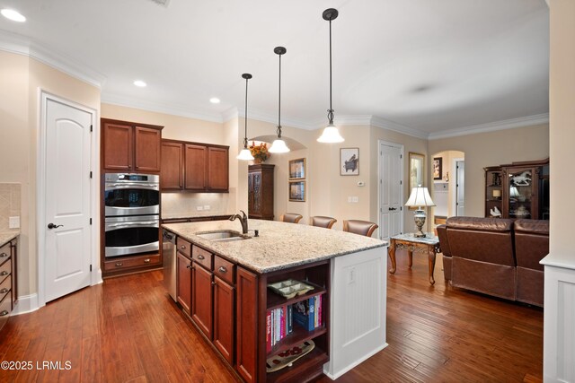 33 Little Pine Ct, Bluffton, SC 29910 - kitchen with light stone counters, a sink, arched walkways, appliances with stainless steel finishes, and dark wood-style floors