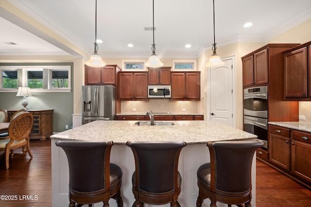 33 Little Pine Ct, Bluffton, SC 29910 - kitchen with light stone counters, tasteful backsplash, a sink, a kitchen island with sink, and stainless steel appliances